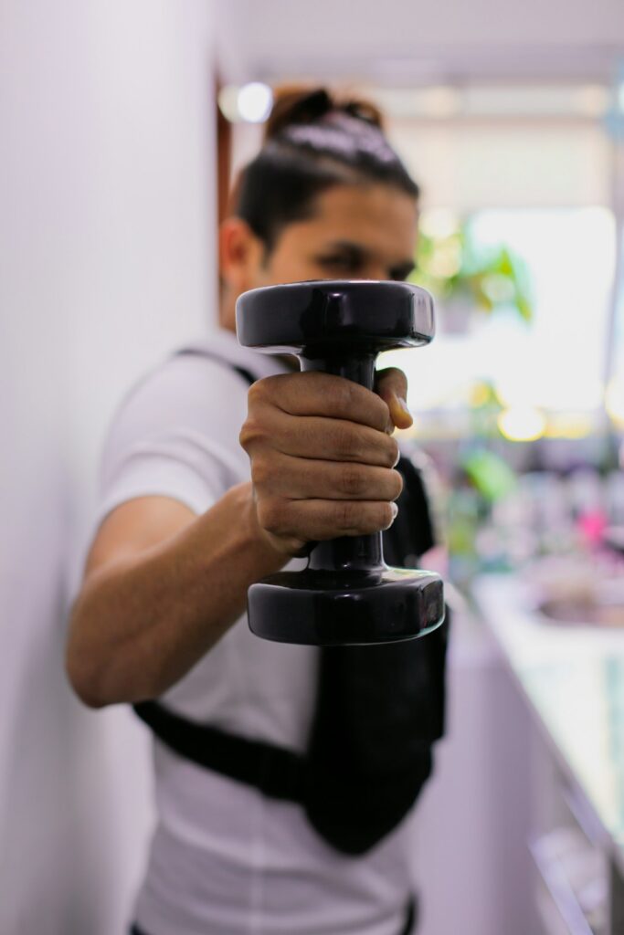 Person performing a controlled split squat beside a backpack and exercise mat in a bright home room.