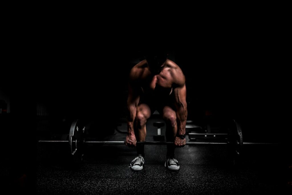 Adults perform controlled resistance exercises in a bright home workout space with dumbbells and a training journal.