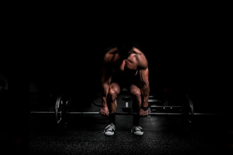 Adults perform controlled resistance exercises in a bright home workout space with dumbbells and a training journal.